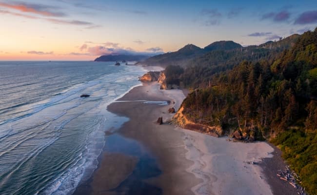 The sun setting over a beach on the Oregon Coast.