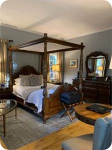 A queen size bed in a bedroom with ornate furniture