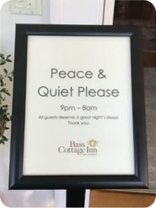 A sign saying "Peace & Quiet Please" with hours and instructions