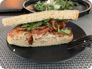 Breakfast sandwich with bacon and greens