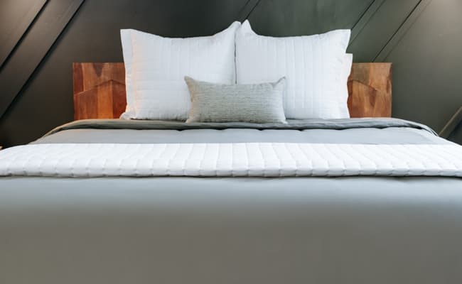 Comfy bed linens on a sleek modern bed