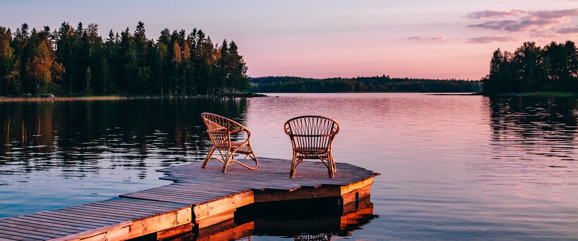 Two chairs on a dock overlooking Lake Ontario, one of the many Great Lakes vacation spots.