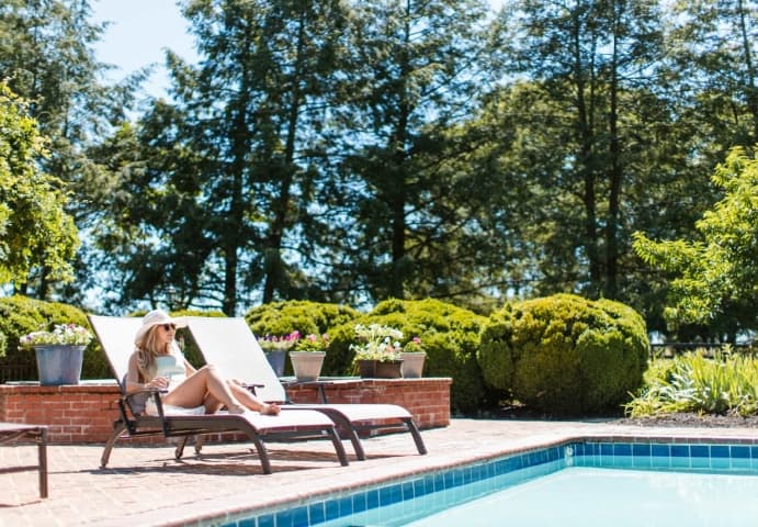 woman lounging at outdoor pool at Villa La Campagnette