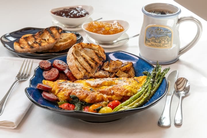 Full breakfast plate with a side of toast and a coffee mug