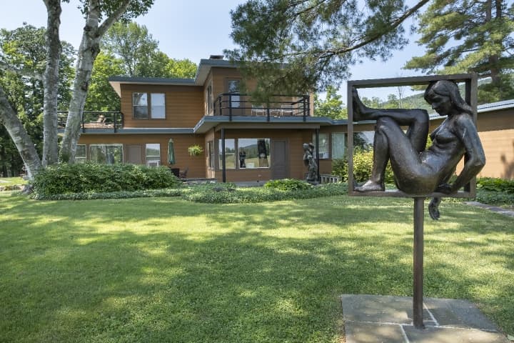 exterior view of property with sculpture in foreground