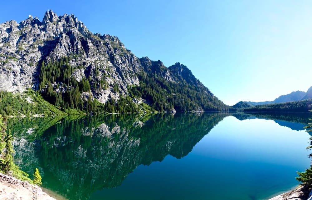 blue lake with mountains in the background