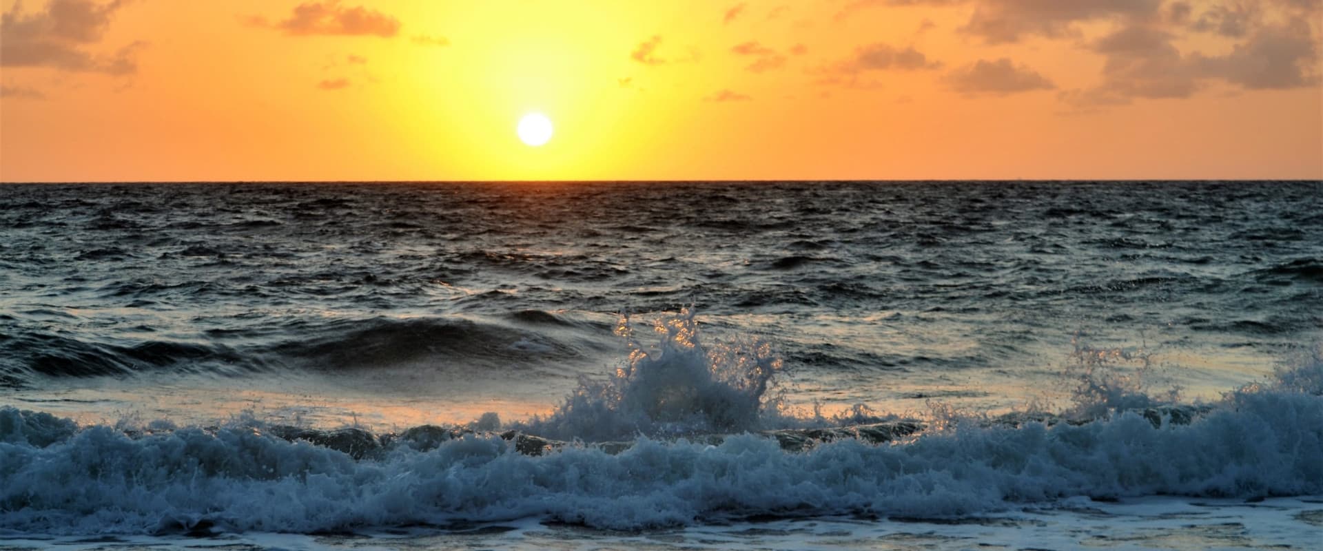 Sunset and waves crashing on the shore of Lake Michigan