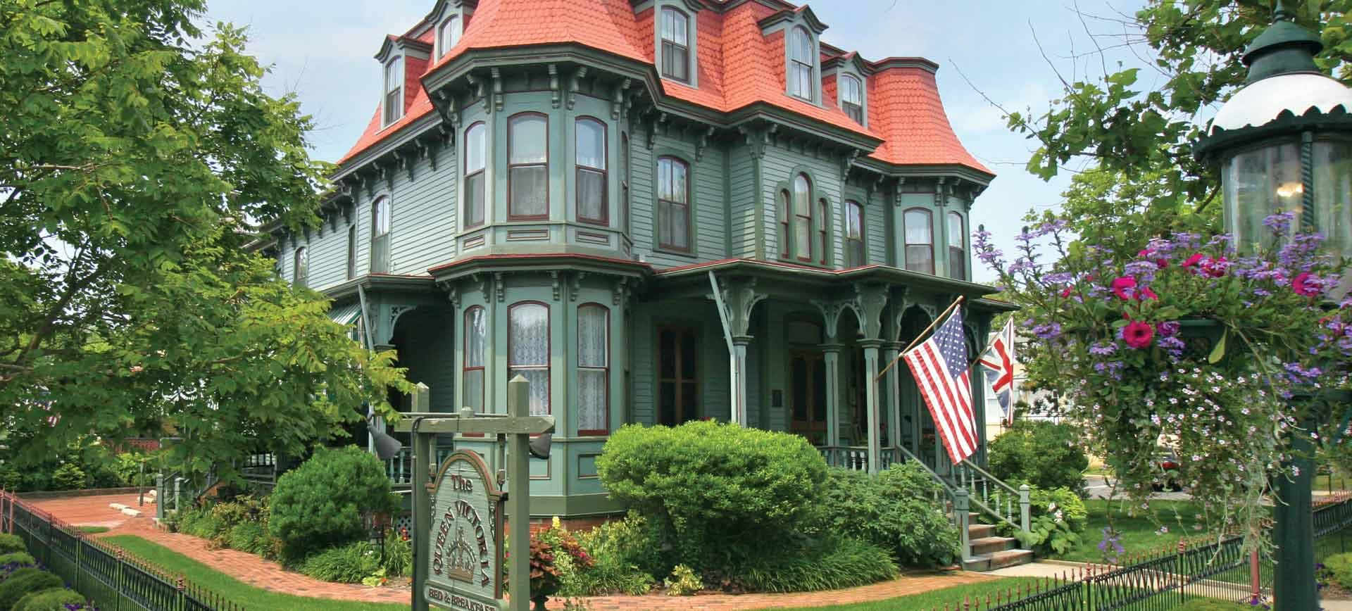 Queen Victoria Bed and Breakfast exterior with an American flag flying off of the front porch