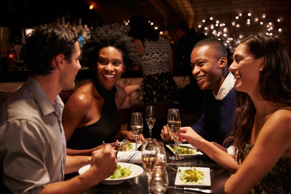 two diverse couples eating out - which is one of the many great things to do in Baltimore, Maryland