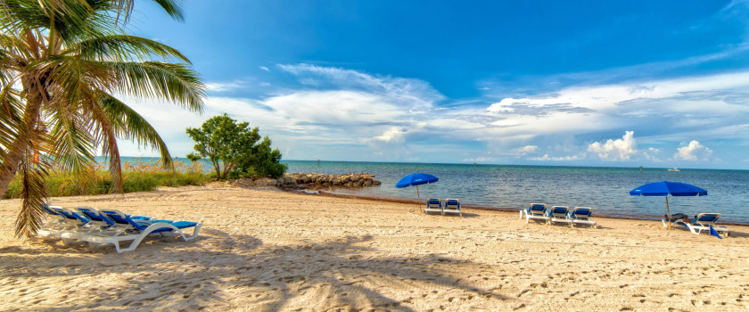 View of a beach with lounge chairs and umbrellas in Key West, Florida
