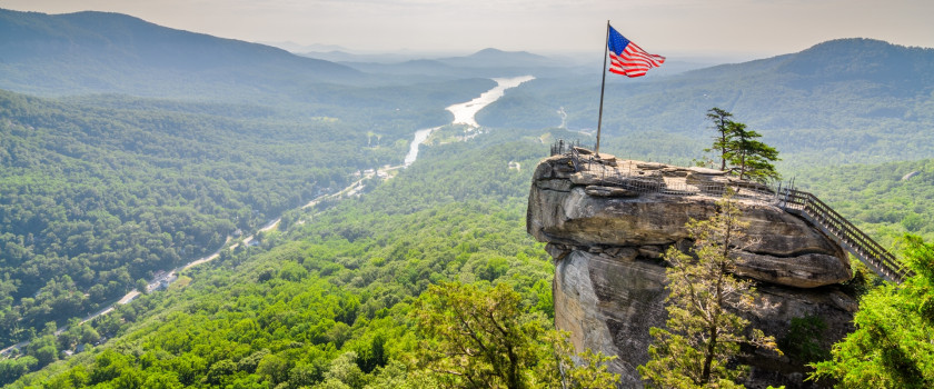 An American flag on a cliff at Chimney Rock State Park