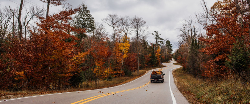 A car driving on a Door County, Wisconsin road in fall