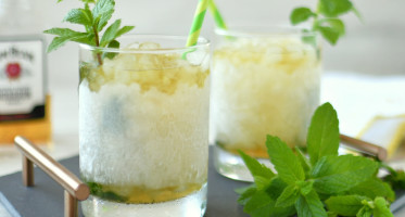 Mint julep cocktails in a frosted glass