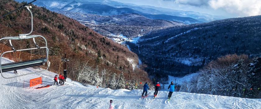 People exiting a ski lift at ski resort in Vermont.