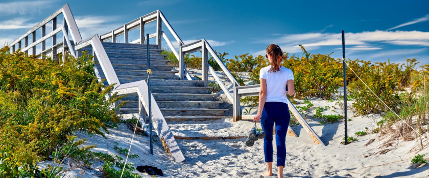 Woman walking to the beach in Ipswich, Massachusetts