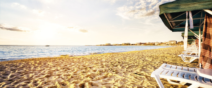 Sandy beach with sunbeds