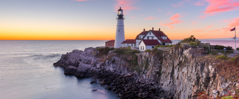 Lighthouse on a cliff over looking a sunset