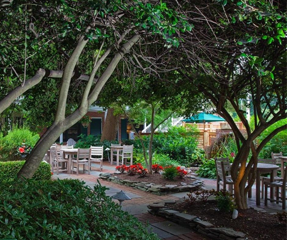 Lush gardens with a sitting area at The Bellmoor Inn & Spa.