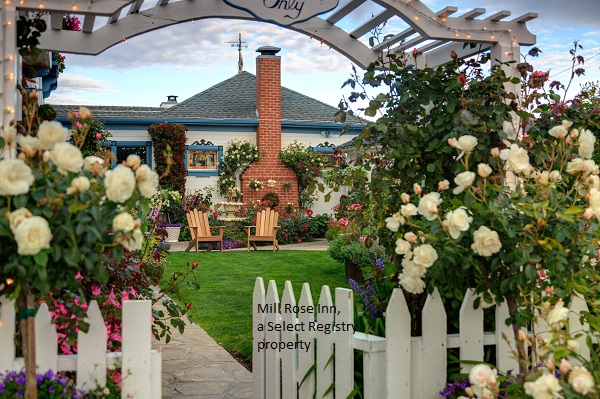 Beautiful flowered arch and picket fence leading into the mill rose inn