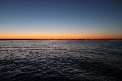 sunset view over the lake at tawas, michigan