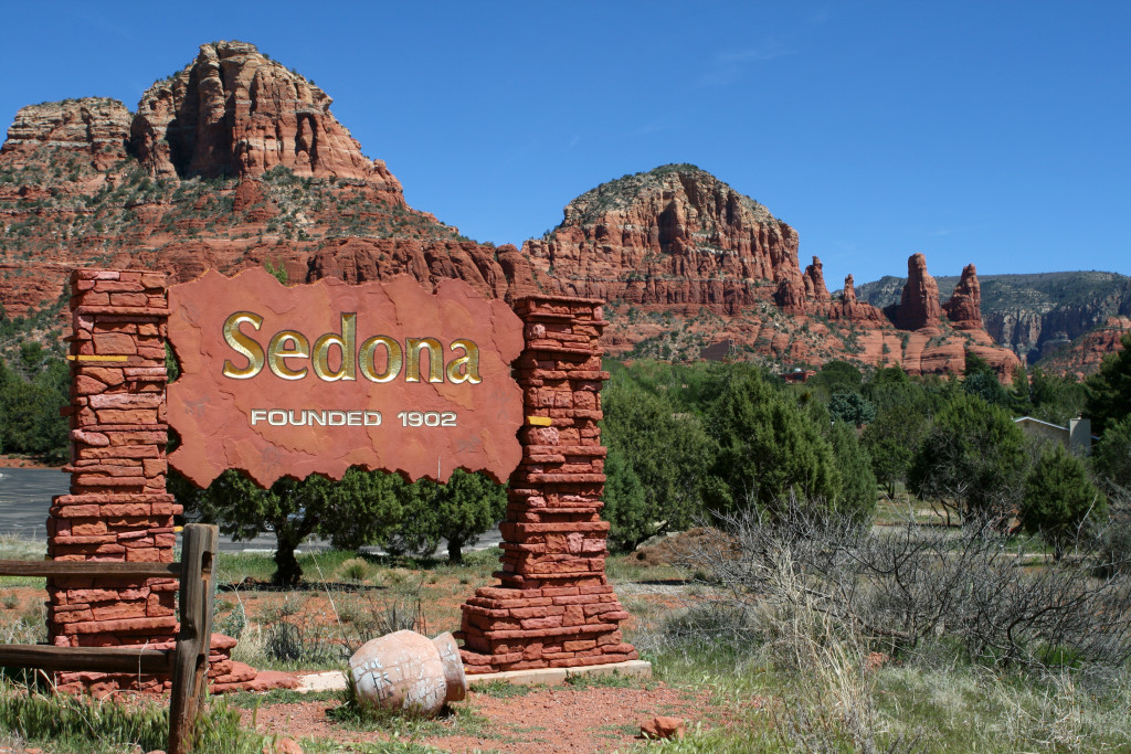 image of red rock formations near sign for sedona