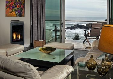 sofas overlooking pacific ocean through french doors