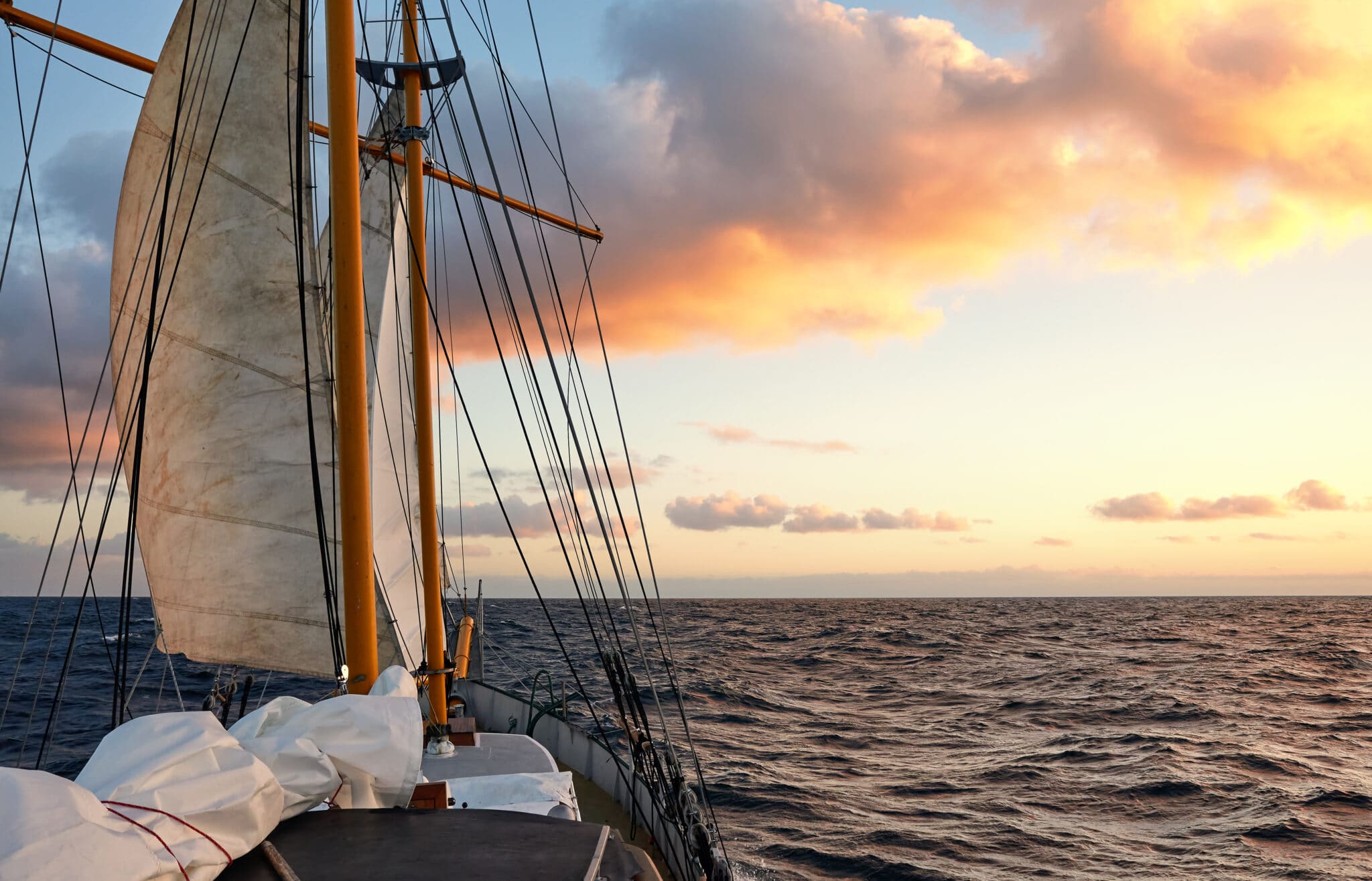 Sailing old schooner at sunset, travel and adventure concept.