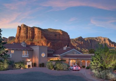 canyon villa in front of red rocks formation