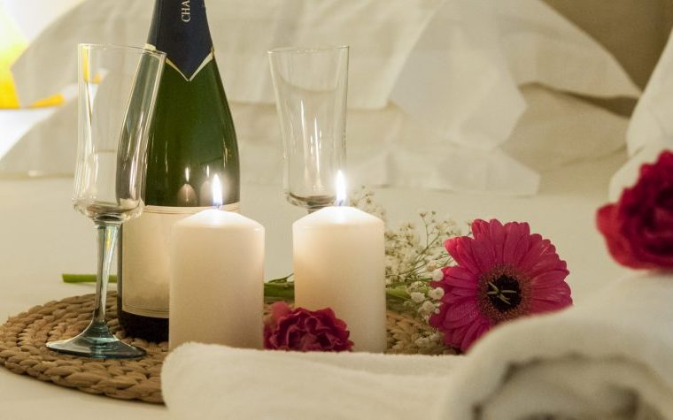 Wine Candles And Flowers On A Bed 1170x475