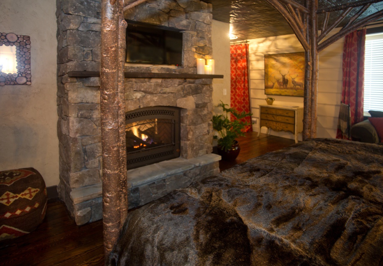 Mountain laurel room at white birch inn with fireplace and fur throw on bed