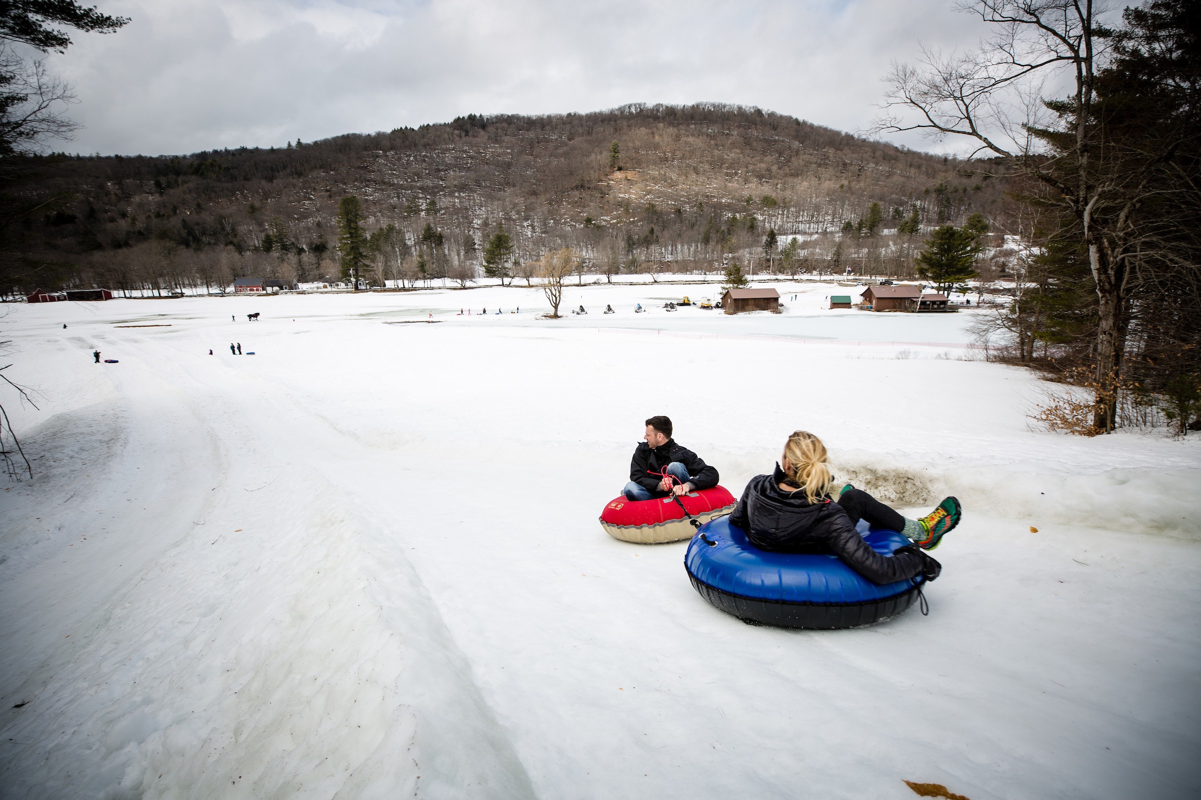 two people on a tubing hill outside
