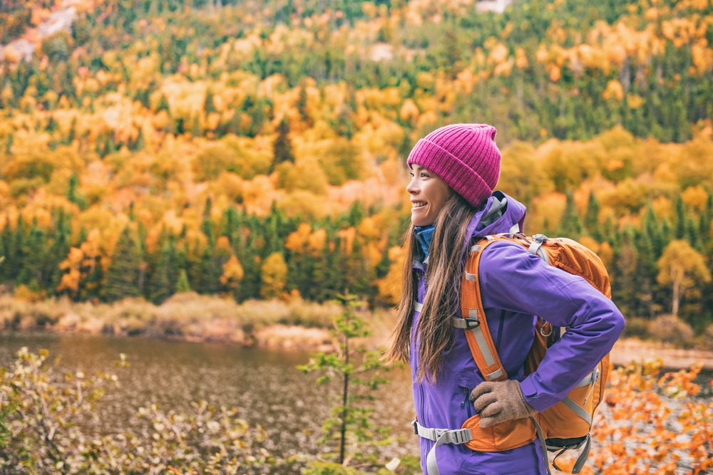A young woman hiking Mount Monadnock in New Hampshire This Fall
