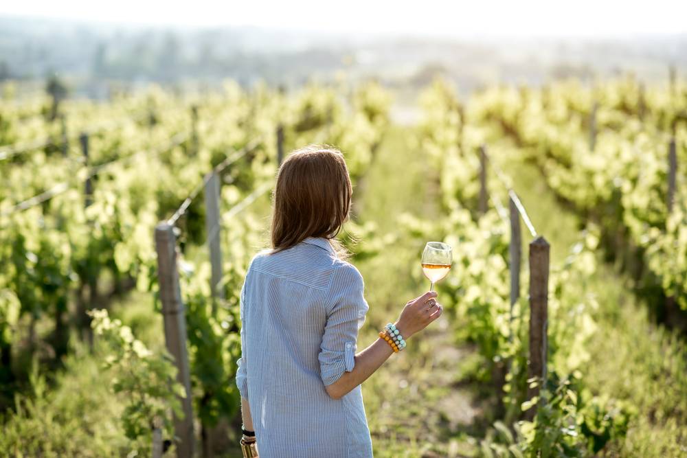 A woman wine tasting at one of the best wine regions in the US