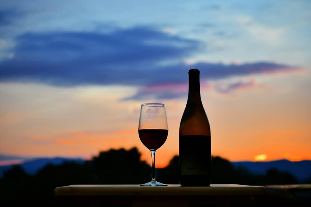 A glass of wine enjoyed at sunset at the best Virginia wineries of 2022