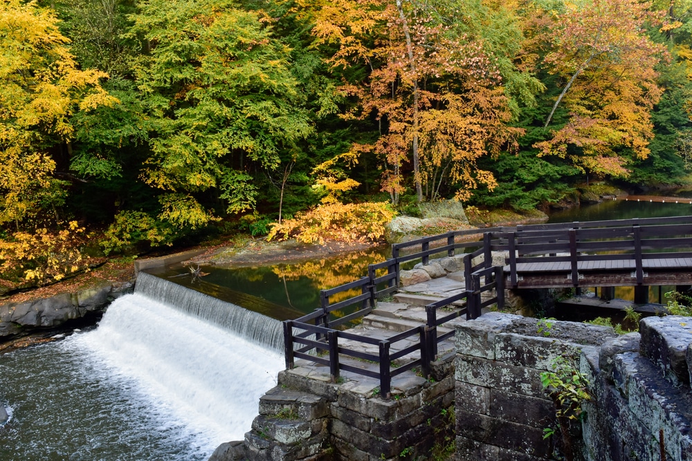 Gorgeous fall foliage around a waterfall at McConnells Mill State Park near New Castle PA